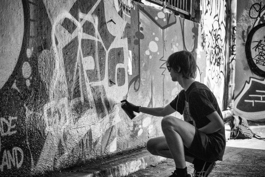 young artist painting graffiti